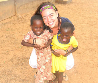 Happy volunteer with kids in Ghana